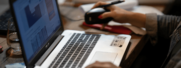 Someone typing on a laptop.