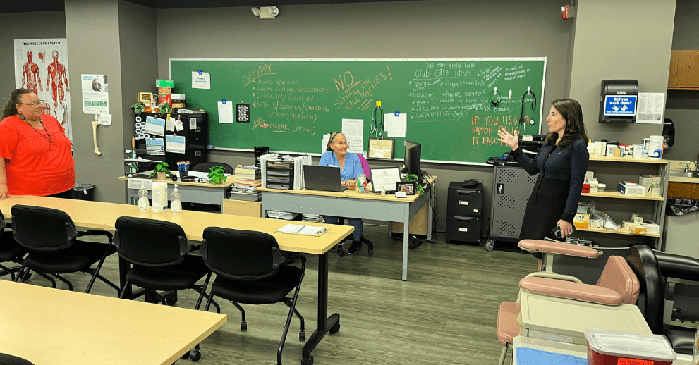 President Hammack (right) asks a question of Jonika Greene (left), Brighton workforce development assistant director, and Tammy Liles (center), medical assisting skills instructor, at Brighton’s Center for Employment Training.