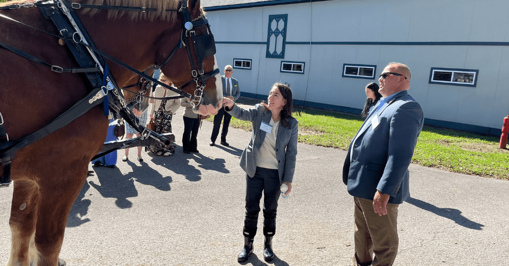 President Hammack gets to know Jace, a draft horse at the Kentucky Horse Park, with Lee Carter, horse park executive director.
