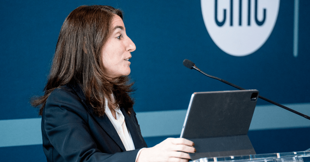 A woman speaks at a podium