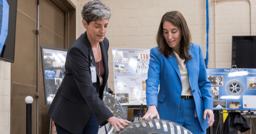 Hammack (right) and Barrow (left) examine one of the roving vehicle tires on display at The Simulated Lunar Operations (SLOPE) Laboratory at NASA’s Glenn Research Center.