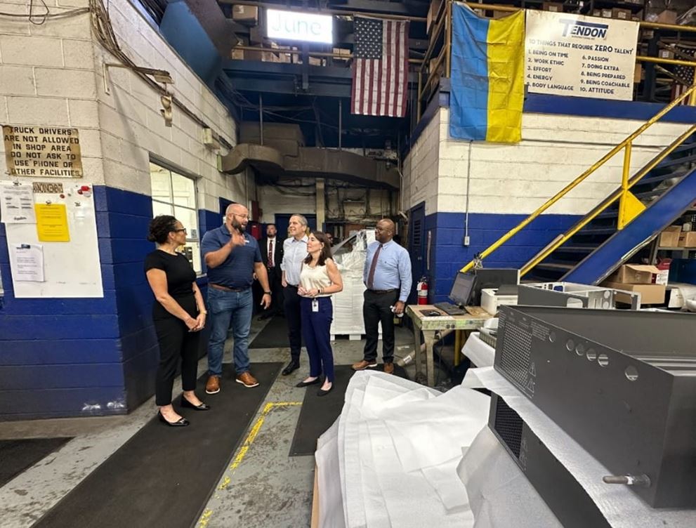A group of people on a factory floor