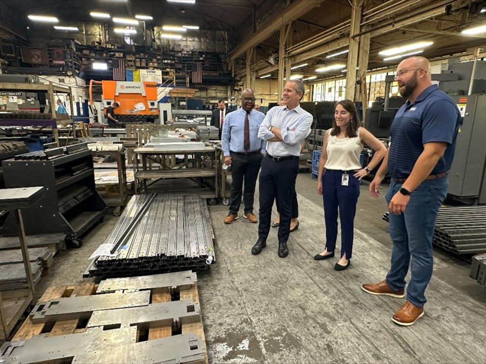 People stand in a manufacturing facility