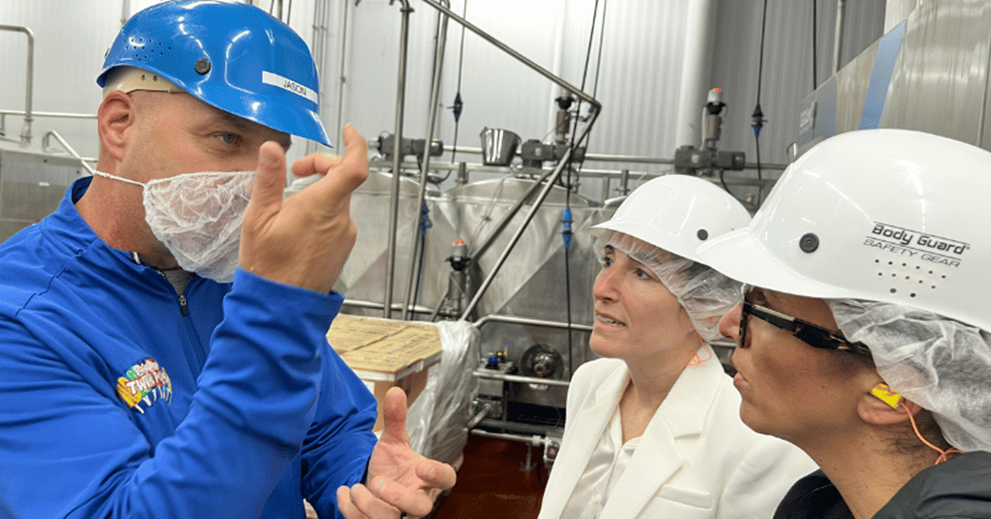 Ziegenfelder operations director Jason Davis describes a portion of the production process to Cleveland Fed president Hammack and senior vice president Courtney Falato.