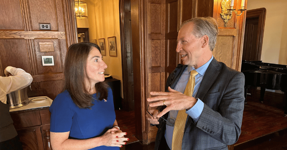 Two people talking in a dining room setting