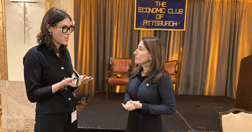 People talking in a ballroom setting