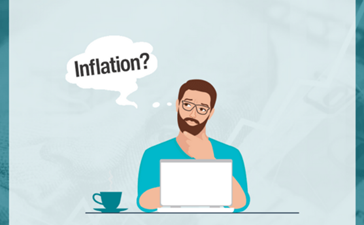 An illustration of a man typing on a laptop at a desk with a thought bubble reading "Inflation?"
