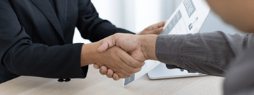 A close-up of two people shaking hands.