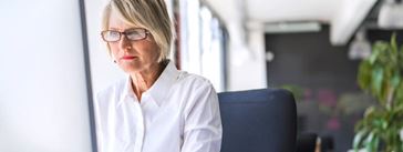 Professional woman in front of the computer in the office