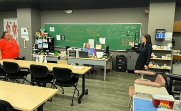 President Hammack (right) asks a question of Jonika Greene (left), Brighton workforce development assistant director, and Tammy Liles (center), medical assisting skills instructor, at Brighton’s Center for Employment Training.