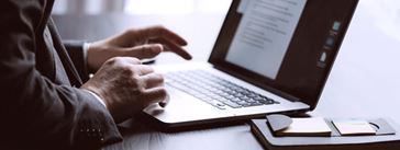 Businessman reading data on laptop