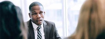 African American financial analyst having a discussion with colleagues