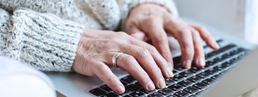 Senior female typing on laptop